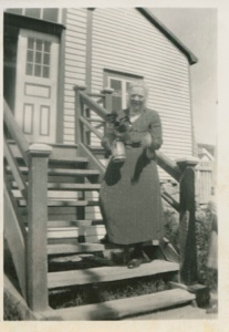 Image: Mrs. Paul Hettasch on steps of her home